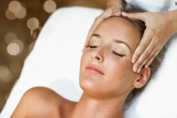 young woman receiving a head massage in a spa center